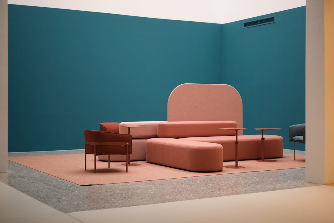 Modern living room with teal walls and pink furniture