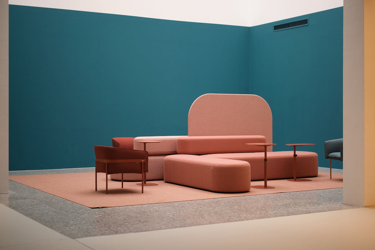 Modern living room with teal walls and pink furniture